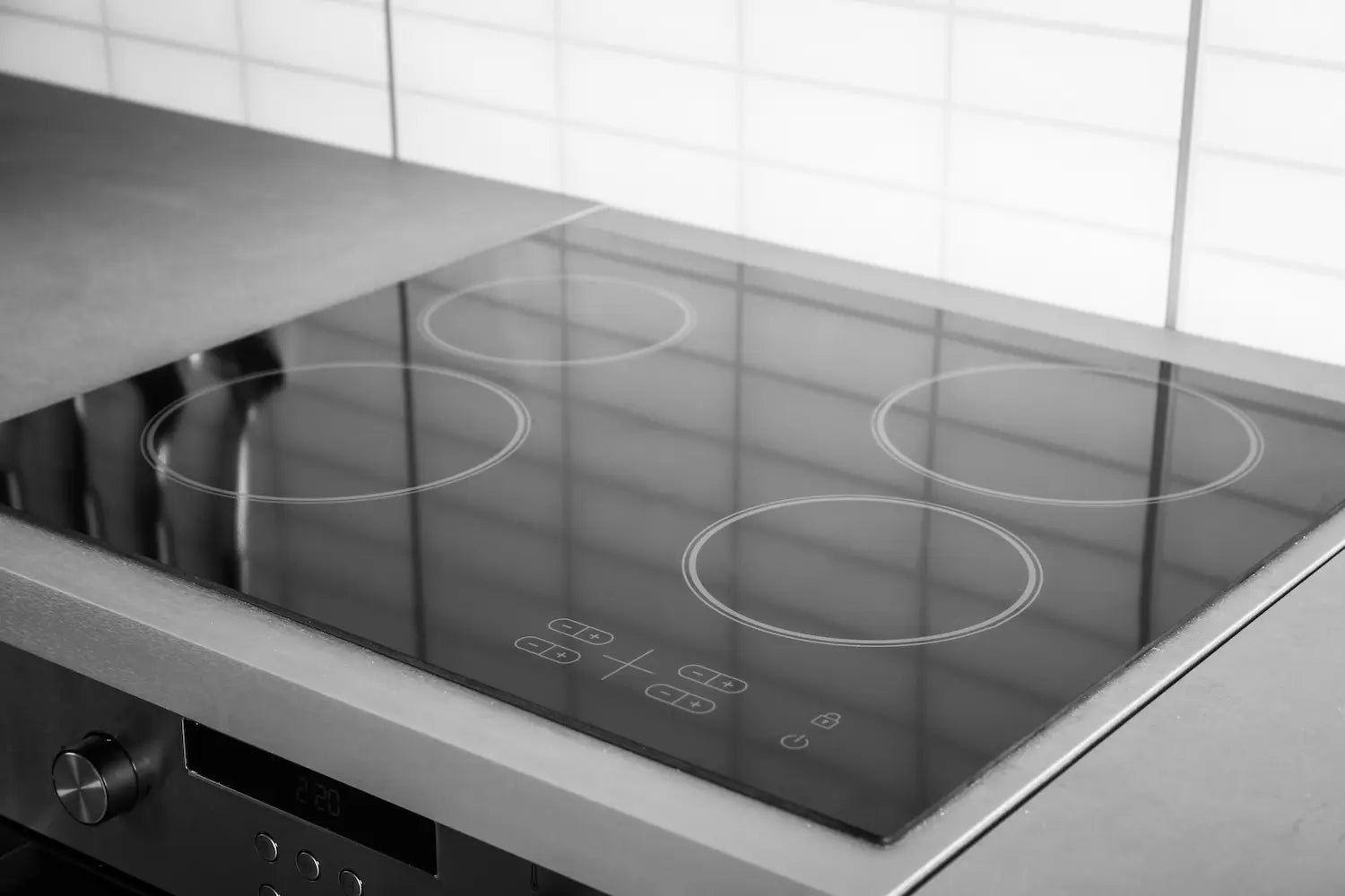cuisine avec une plaque vitrocéramique noir avec 4 chauffes